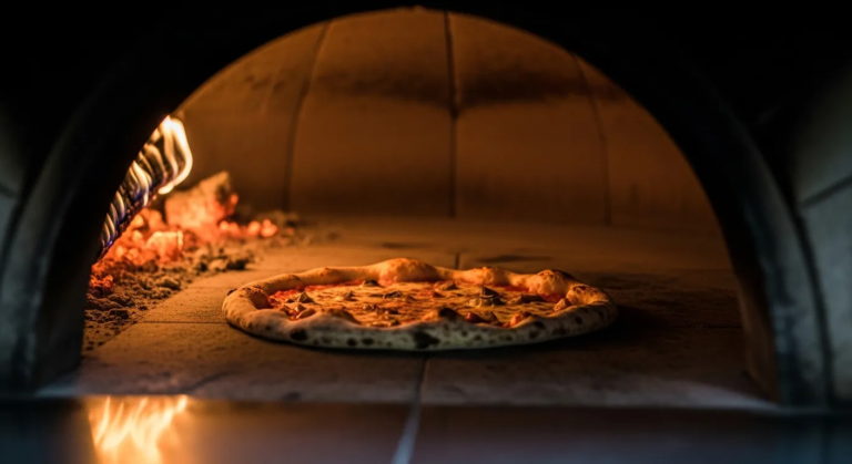 Image of a pizza in a wood fire oven for best pizza in Calgary